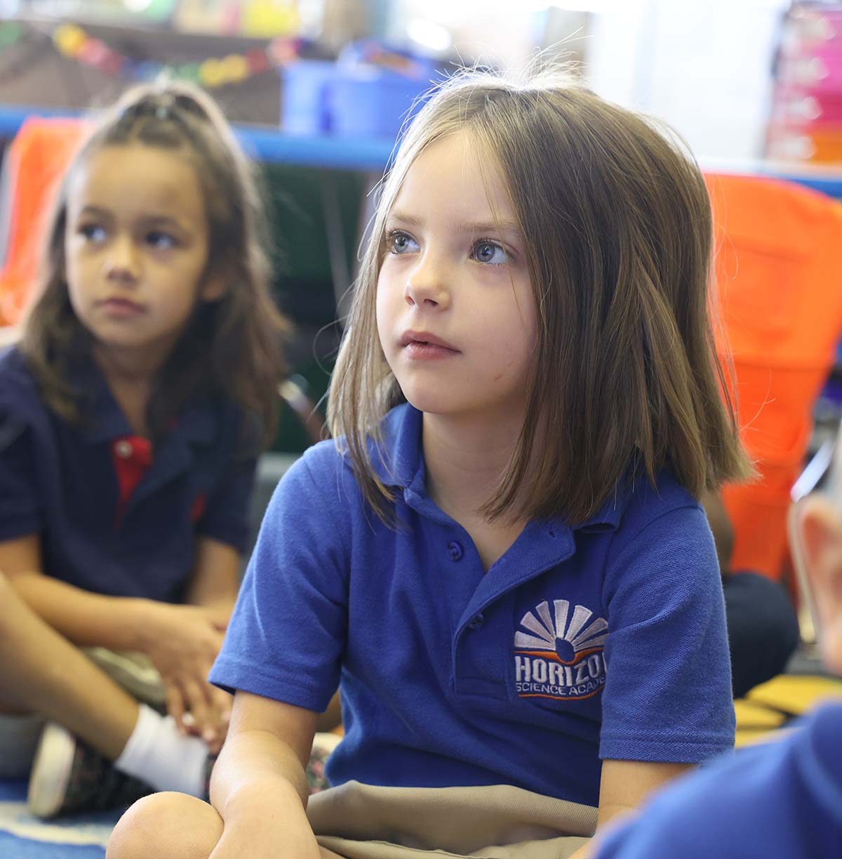Student drawing in a classroom.